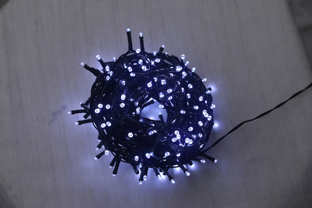 String lights, dark green wires, white light